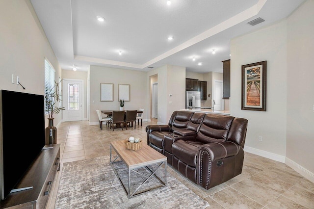 4817 Saint Armands Way, Westlake, FL 33470 - living room featuring baseboards, light tile patterned floors, a tray ceiling, and recessed lighting