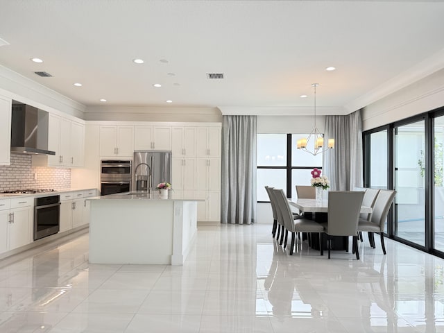 8803 Skyward St, Boca Raton, FL 33496 - kitchen with wall chimney range hood, plenty of natural light, stainless steel appliances, decorative backsplash, and ornamental molding