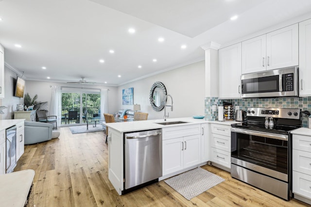 200 E Royal Palm Rd Unit 3040, Boca Raton, FL 33432 - kitchen featuring stainless steel appliances, a sink, ornamental molding, open floor plan, and a peninsula