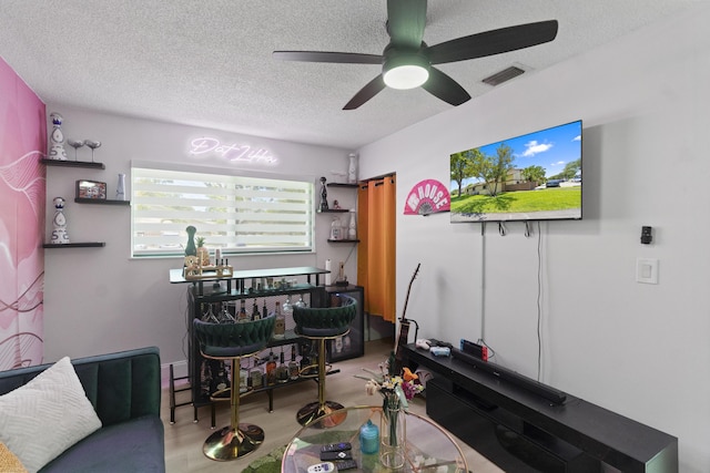 10650 NW 30th Pl Unit 1, Sunrise, FL 33322 - living room featuring a ceiling fan, a textured ceiling, and wood finished floors