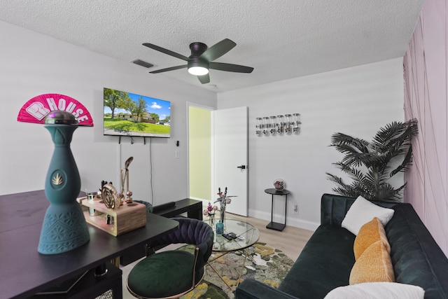 10650 NW 30th Pl Unit 1, Sunrise, FL 33322 - living room with ceiling fan, light wood-style flooring, a textured ceiling, and baseboards