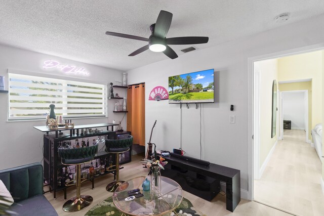 10650 NW 30th Pl Unit 1, Sunrise, FL 33322 - living room featuring wood finished floors, a ceiling fan, and a textured ceiling