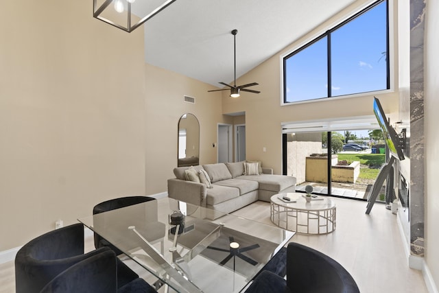 10650 NW 30th Pl Unit 1, Sunrise, FL 33322 - living room with high vaulted ceiling, ceiling fan, wood finished floors, arched walkways, and baseboards