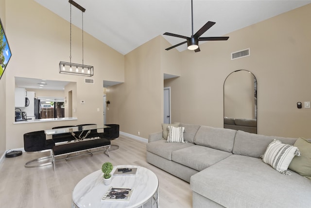 10650 NW 30th Pl Unit 1, Sunrise, FL 33322 - living room featuring high vaulted ceiling, light wood-style floors, a ceiling fan, and baseboards