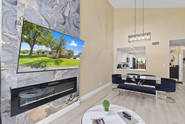10650 NW 30th Pl Unit 1, Sunrise, FL 33322 - living area featuring wood finished floors, baseboards, and a towering ceiling