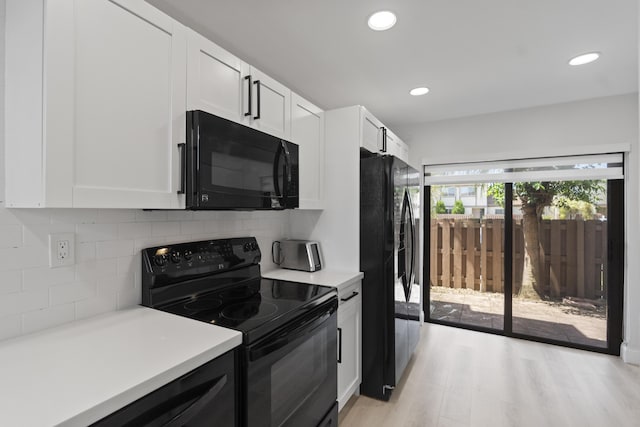 10650 NW 30th Pl Unit 1, Sunrise, FL 33322 - kitchen with black appliances, light countertops, white cabinetry, tasteful backsplash, and recessed lighting