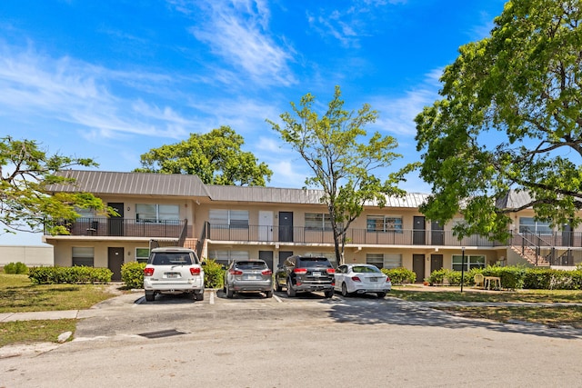300 NW 30th Ct Unit 202, Pompano Beach, FL 33064 - view of property featuring uncovered parking