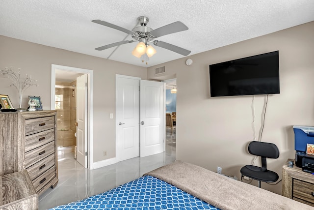 2018 S Federal Hwy Unit 304, Boynton Beach, FL 33435 - tiled bedroom with a textured ceiling, a ceiling fan, and ensuite bathroom
