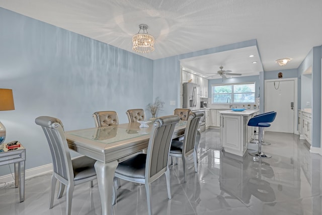 2018 S Federal Hwy Unit 304, Boynton Beach, FL 33435 - dining area with a chandelier, baseboards, ceiling fan, and light marble finish floors