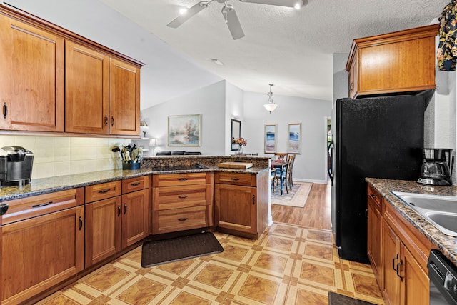 15180 69th Dr N, Palm Beach Gardens, FL 33418 - kitchen featuring brown cabinets, a peninsula, vaulted ceiling, black appliances, and ceiling fan