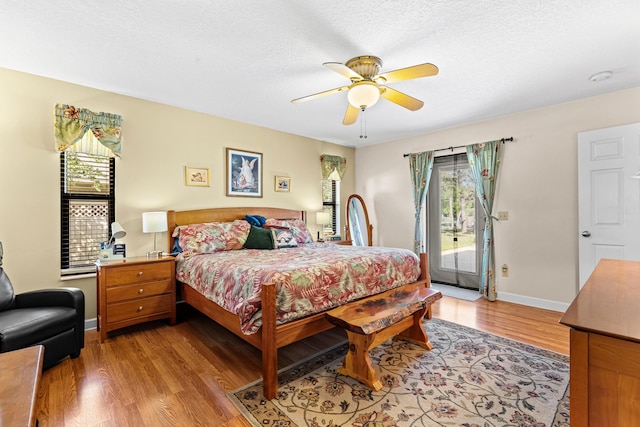 15180 69th Dr N, Palm Beach Gardens, FL 33418 - bedroom with access to exterior, multiple windows, light wood finished floors, and ceiling fan