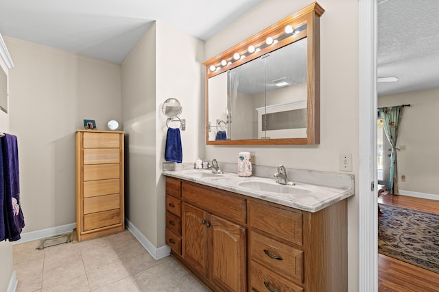 15180 69th Dr N, Palm Beach Gardens, FL 33418 - full bathroom featuring baseboards, double vanity, and tile patterned floors