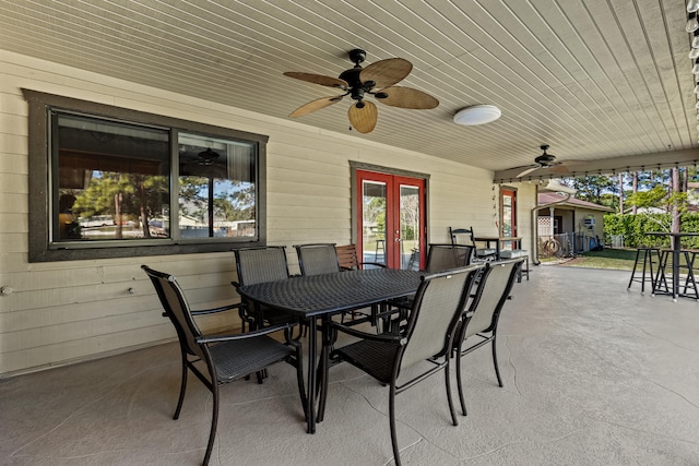 15180 69th Dr N, Palm Beach Gardens, FL 33418 - view of patio with french doors, outdoor dining space, and a ceiling fan