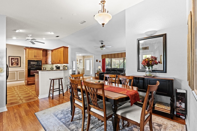 15180 69th Dr N, Palm Beach Gardens, FL 33418 - dining room featuring a ceiling fan, vaulted ceiling, and light wood-style flooring