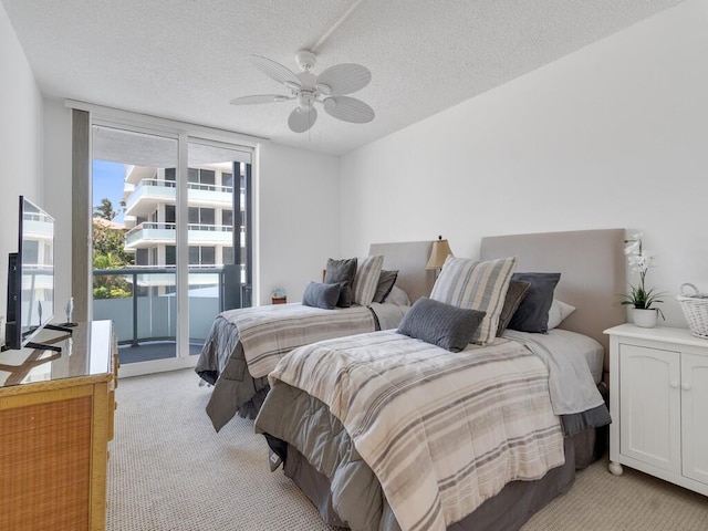 3554 Ocean Dr Unit 202, Vero Beach, FL 32963 - bedroom with light carpet, access to outside, a textured ceiling, and a ceiling fan