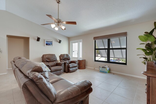 11195 N 159th Ct N, Jupiter, FL 33478 - living area featuring lofted ceiling, light tile patterned floors, a ceiling fan, a textured ceiling, and baseboards
