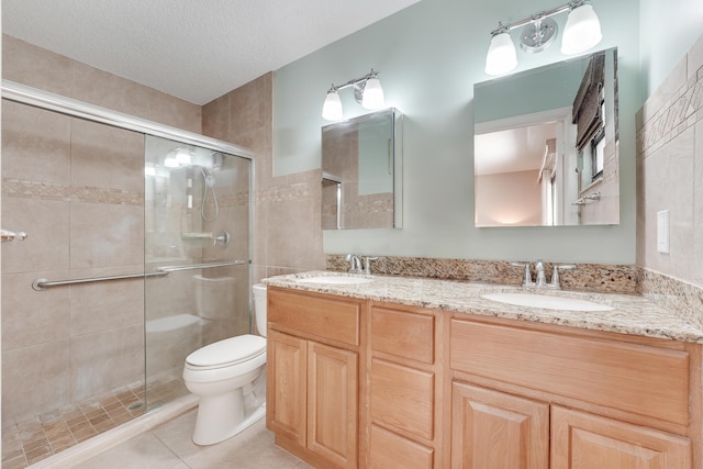 11195 N 159th Ct N, Jupiter, FL 33478 - full bathroom with a stall shower, toilet, double vanity, tile patterned floors, and a textured ceiling
