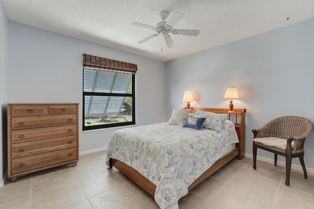 11195 N 159th Ct N, Jupiter, FL 33478 - bedroom featuring light tile patterned floors, a textured ceiling, baseboards, and ceiling fan