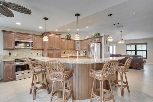 11195 N 159th Ct N, Jupiter, FL 33478 - kitchen with appliances with stainless steel finishes, a ceiling fan, lofted ceiling, tasteful backsplash, and light tile patterned floors