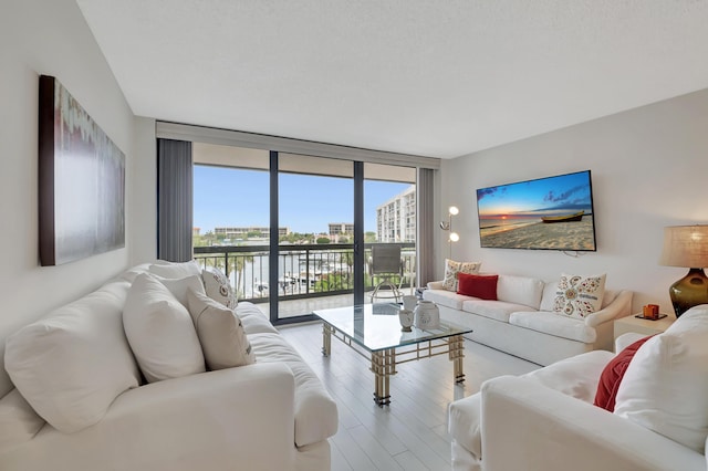 2697 N Ocean Blvd Unit 407-F, Boca Raton, FL 33431 - living room with floor to ceiling windows and wood finished floors