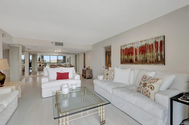 2697 N Ocean Blvd Unit 407-F, Boca Raton, FL 33431 - living area featuring wood finished floors and a textured ceiling