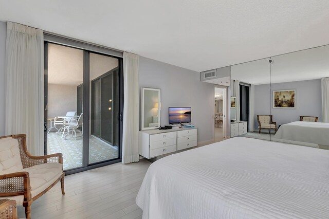 2697 N Ocean Blvd Unit 407-F, Boca Raton, FL 33431 - bedroom featuring light wood finished floors and access to outside