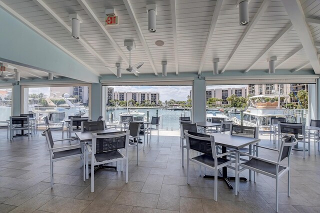 2697 N Ocean Blvd Unit 407-F, Boca Raton, FL 33431 - view of patio with a water view, a ceiling fan, and outdoor dining area