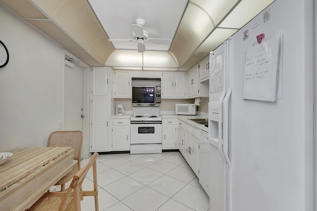 2697 N Ocean Blvd Unit 407-F, Boca Raton, FL 33431 - kitchen with white appliances, a ceiling fan, white cabinets, and light tile patterned floors