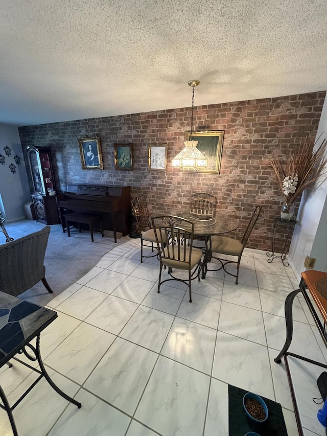 262 Sussex M, West Palm Beach, FL 33417 - dining space featuring brick wall and a textured ceiling