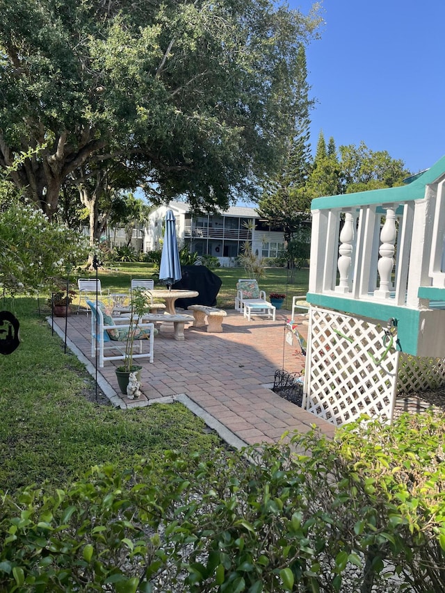 262 Sussex M, West Palm Beach, FL 33417 - wooden terrace with a patio and a yard