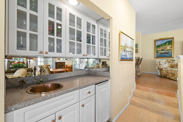 17187 Bay St, Jupiter, FL 33477 - bar with a sink, baseboards, and light tile patterned flooring