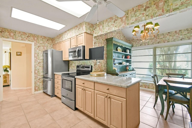 17187 Bay St, Jupiter, FL 33477 - kitchen featuring appliances with stainless steel finishes, wallpapered walls, light brown cabinets, light tile patterned flooring, and baseboards