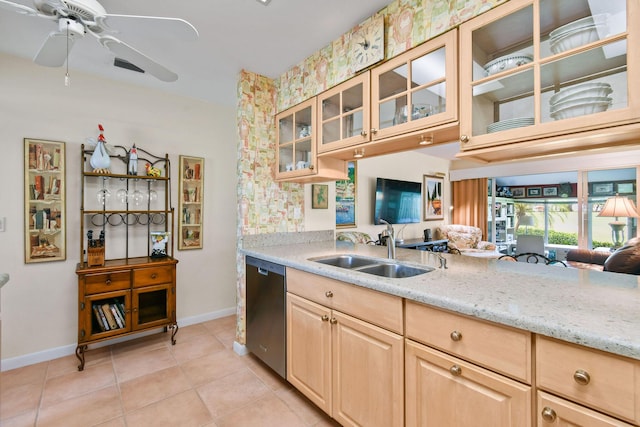 17187 Bay St, Jupiter, FL 33477 - kitchen with stainless steel dishwasher, a sink, light brown cabinetry, and baseboards