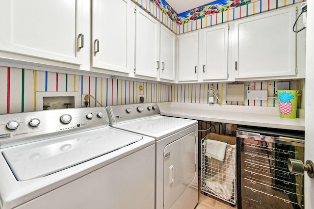 17187 Bay St, Jupiter, FL 33477 - laundry area featuring separate washer and dryer, cabinet space, wallpapered walls, wine cooler, and light tile patterned floors