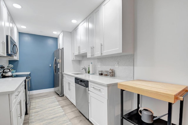 10164 40th Way S Unit 256, Boynton Beach, FL 33436 - kitchen featuring stainless steel appliances, a sink, light countertops, decorative backsplash, and recessed lighting
