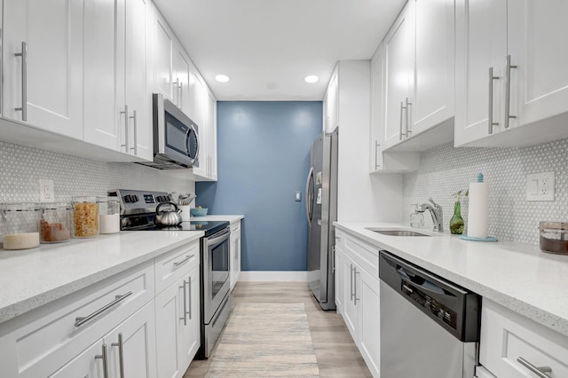 10164 40th Way S Unit 256, Boynton Beach, FL 33436 - kitchen with appliances with stainless steel finishes, a sink, white cabinets, recessed lighting, and backsplash