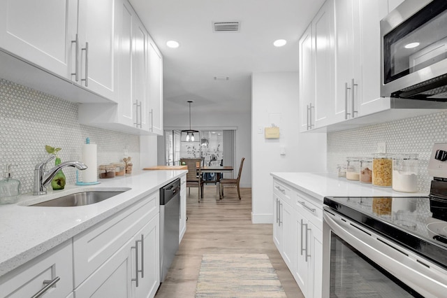10164 40th Way S Unit 256, Boynton Beach, FL 33436 - kitchen featuring appliances with stainless steel finishes, a sink, light wood finished floors, and white cabinets