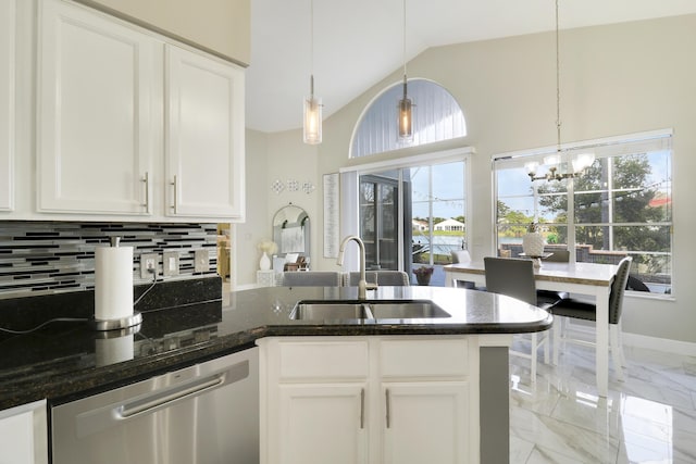 kitchen with stainless steel dishwasher, a sink, light marble finish floors, a peninsula, and white cabinetry