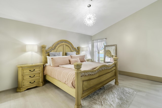 bedroom featuring baseboards, light wood-type flooring, lofted ceiling, and a chandelier