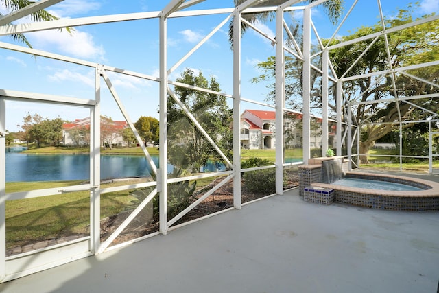 unfurnished sunroom featuring a hot tub and a water view