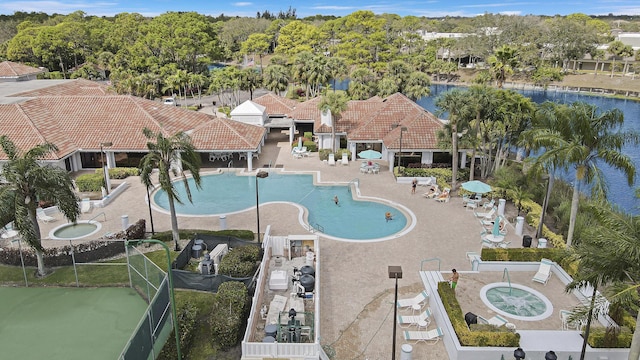 aerial view of a pool area and a large body of water