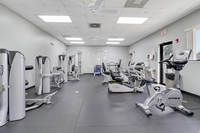gym featuring a paneled ceiling and ceiling fan