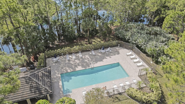 aerial view of property and surrounding area with a pool area