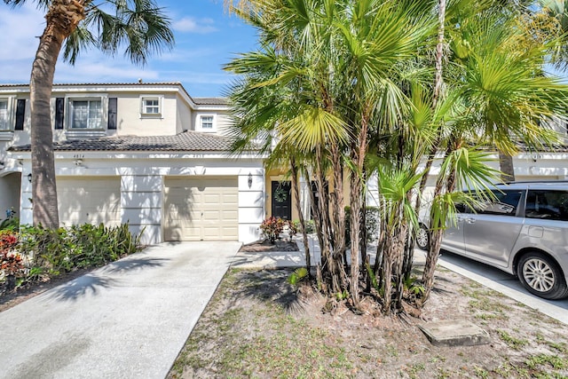 4838 Palmbrooke Cir, West Palm Beach, FL 33417 - view of front of property with stucco siding, concrete driveway, and a tile roof