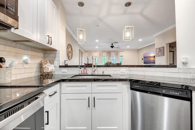 4838 Palmbrooke Cir, West Palm Beach, FL 33417 - kitchen with stainless steel appliances, ornamental molding, white cabinets, decorative backsplash, and dark stone counters