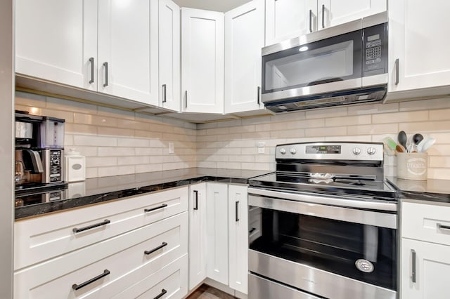 4838 Palmbrooke Cir, West Palm Beach, FL 33417 - kitchen featuring appliances with stainless steel finishes, white cabinetry, tasteful backsplash, and dark stone countertops