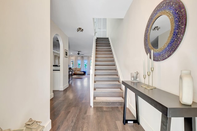 4838 Palmbrooke Cir, West Palm Beach, FL 33417 - stairway featuring wood finished floors, arched walkways, baseboards, and a ceiling fan