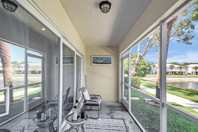 4838 Palmbrooke Cir, West Palm Beach, FL 33417 - sunroom featuring a water view, unfinished concrete flooring, and a residential view