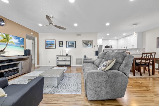 3561 Pine Tree Ct Unit A-2, Greenacres, FL 33463 - living room featuring a ceiling fan, light wood-style floors, baseboards, and recessed lighting