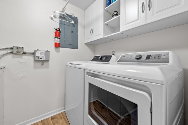 3561 Pine Tree Ct Unit A-2, Greenacres, FL 33463 - washroom featuring washing machine and clothes dryer, cabinet space, light wood-type flooring, and baseboards